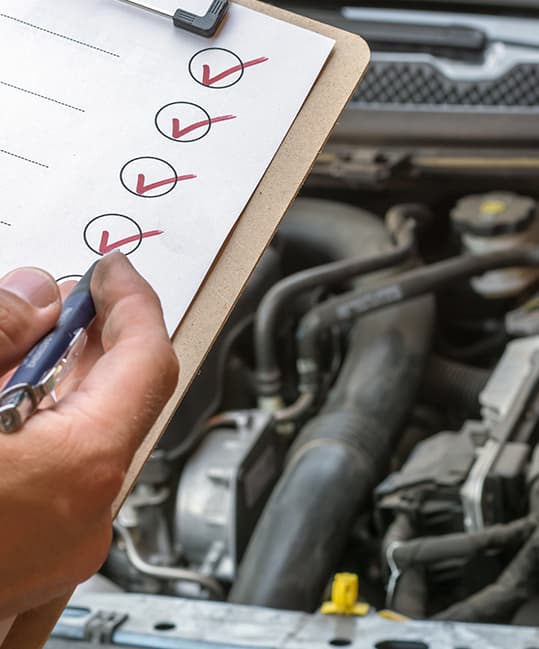 Technician completing an MOT inspection checklist