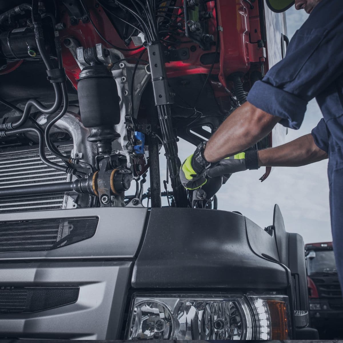 Technician repairing a commercial vehicle engine